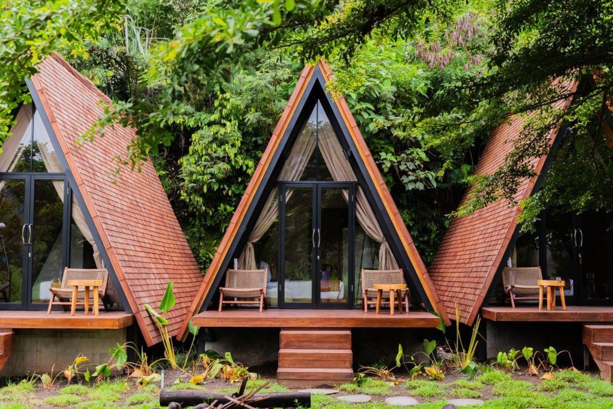 A-frame cabins at dusk with fire
